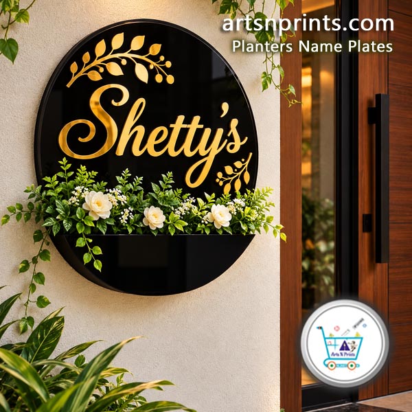 Shetty's Acrylic Planter Name Plates by artsNprints shipping across India no cod Circular black acrylic house name plate with custom gold script lettering "Shetty's" and an integrated planter box with white flowers installed on an outdoor wall.